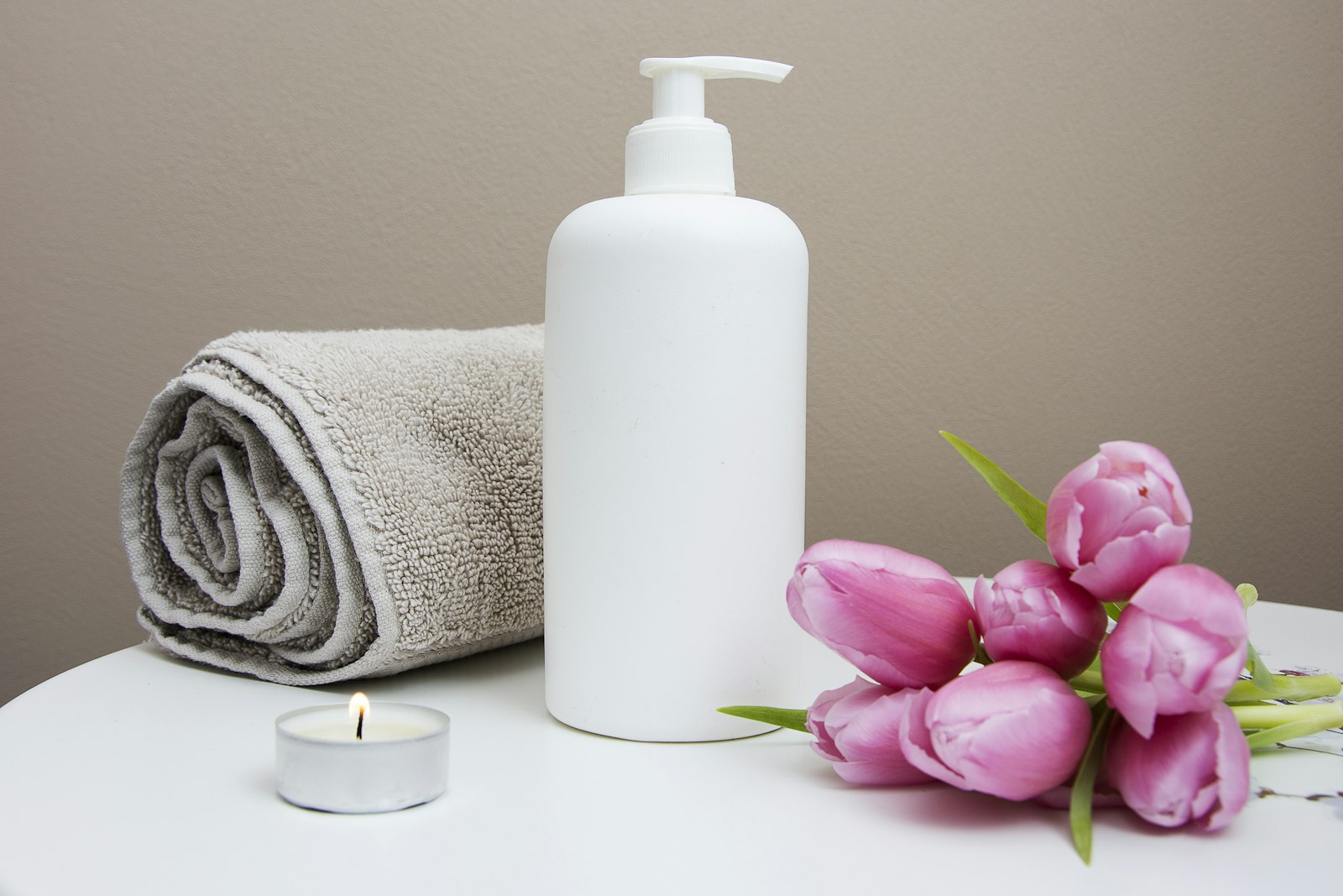Late-night outcall massage setup in a hotel room with soft lighting and towels